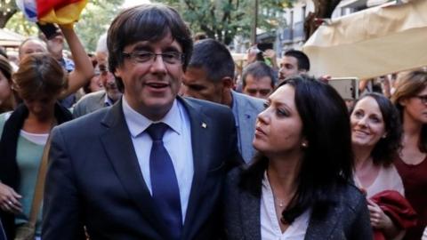 Sacked Catalan President Carles Puigdemont walks with his wife Marcela Topor during a walkabout in Girona, October 28, 2017