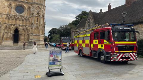 Two fire engines parked outside Lincoln Cathedral.