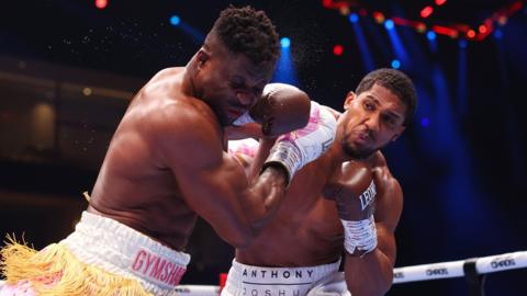 Francis Ngannou is punched by Anthony Joshua