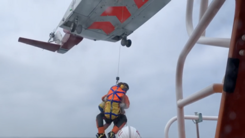 Man being winched into aircraft