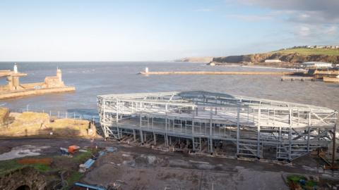The completed steel frame of The Edge with the Cumbrian coast in the background
