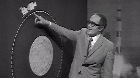 James Burke and a big board showing the distance between Apollo 10 and the Moon