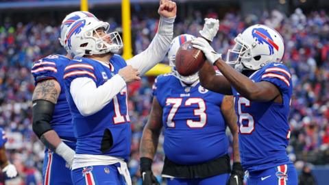 Three Buffalo Bills player, including quarterback Josh Allen, celebrate a touchdown