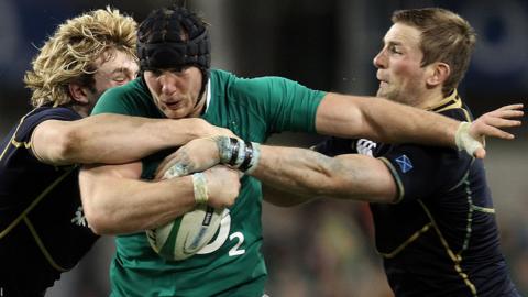 Stephen Ferris attempts to bulldoze his way past Scotland's Richie Gray and John Barclay in 2002