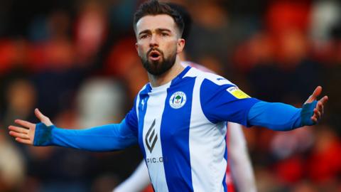 Gwion Edwards of Wigan reacts during a game against Cheltenham