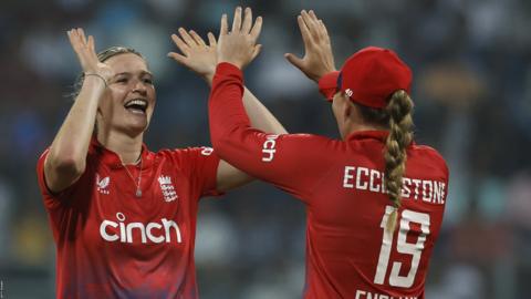Lauren Bell (left) and Sophie Ecclestone (right) celebrate a wicket for England