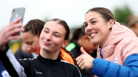 Mary Earps poses for a selfie with an England fan