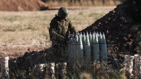 An Israeli soldier inspects artillery near the border between Israel and Gaza