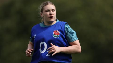 England Women's rugby international Mackenzie Carson wearing a blue bib while taking part in a training session with her country.
