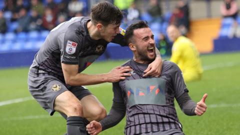 Aaron Wildig of Newport County celebrates with Charlie McNeill