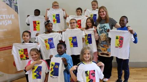 North West Migrants Forum summer scheme children holding tshirts