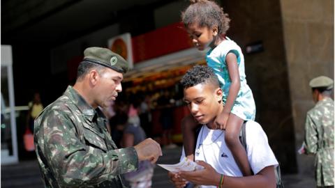 An army soldier explain how to combat the Aedes aegypti mosquito at the Central station in Rio de Janeiro, 13 Feb 2016.