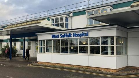 It is the outside of a West Suffolk hospital. It's a 1960s building and had a big sign on blue writing saying West Suffolk Hospital.