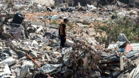 A man stands in the midst of devastation in Khan Younis after 4 months of Israeli bombardment in Khan Yunis