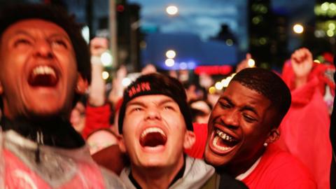 Three Toronto fans react in the Jurassic Park fan zone