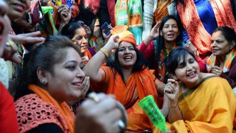 Supporters of the Bharatiya Janata Party celebrate outside the party headquarters in Delhi