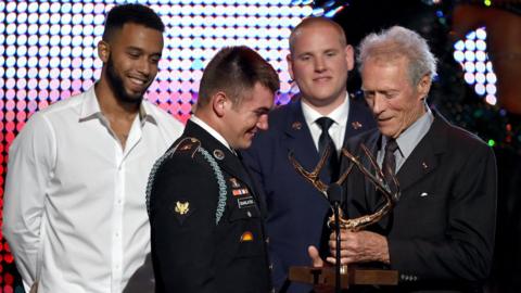 Spencer Stone and Alek Skarlatos, and their friend Anthony Sadler accepting a Hero Award from actor/director Clint Eastwood onstage during Spike TV's 10th Annual Guys Choice Awards in 2016