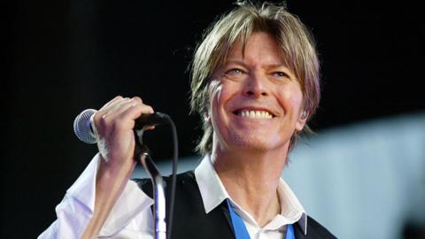 David Bowie smiling with a microphone