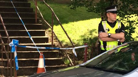 Policeman outside cordoned off flat