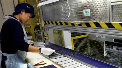 Woman in a solar panel factory