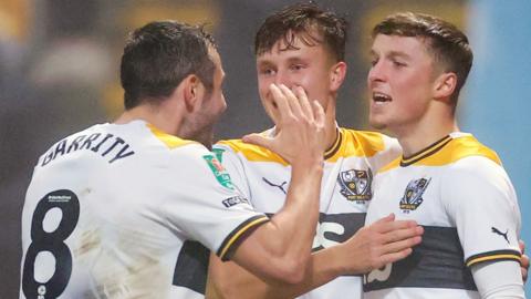 Port Vale players celebrate their decisive late goal