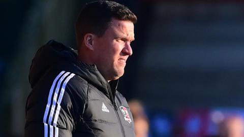 Gary Caldwell watches his Exeter City side lose at Fleetwood Town