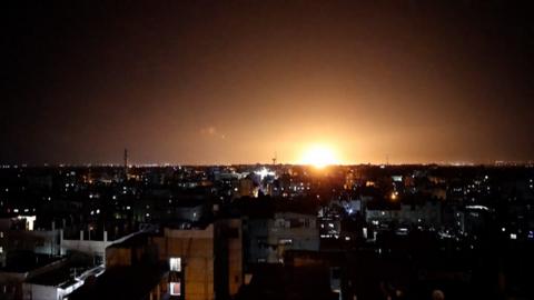 An explosion lights up the skyline in Khan Yunis, in the southern Gaza Strip