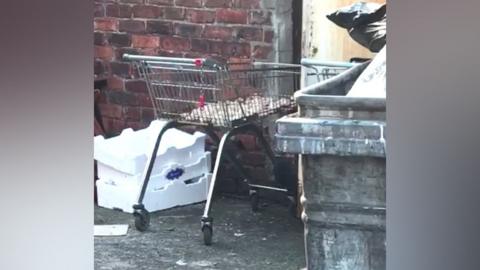 A still from the video showing the trolley, which appears to have chicken on