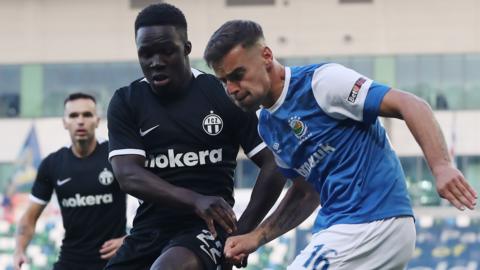 Linfield's Matthew Clarke battles with FC Zurich goalscorer Tosin Aiyegun