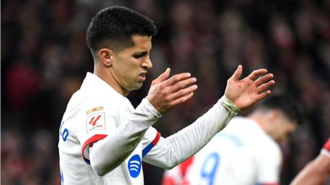 Joao Cancelo puts up his arms in frustration