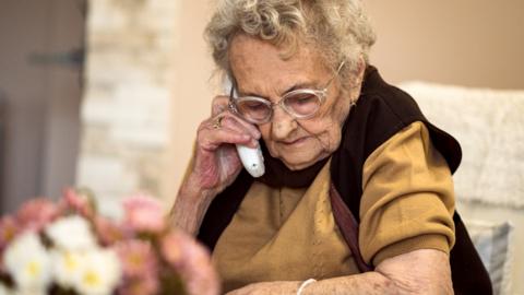 Elderly woman on a landline phone