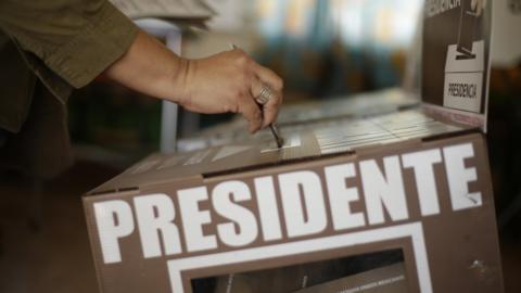 Voter drops a ballot into a box at a polling station in Ciudad Juarez, Mexico, July 1, 2018