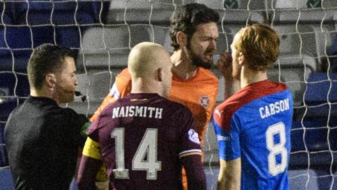 Craig Gordon of Hearts confronts Inverness midfielder David Carson