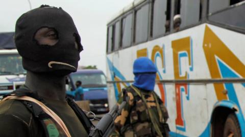 Mutinying soldiers stand guard at a check point at the entrance to Bouake, Ivory Coast, May 15, 2015.