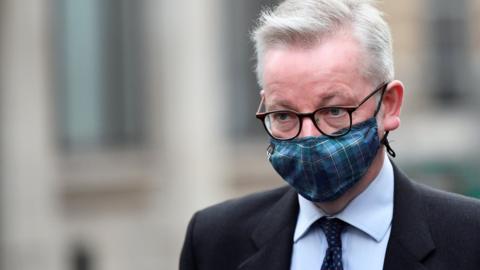 Michael Gove in a tartan mask