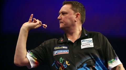 Kevin Painter throws a dart on the oche