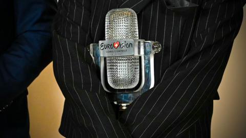 Austrian singer Johannes Pietsch aka JJ (C), winner of the 2025 Eurovision Song Contest, poses with his trophy.