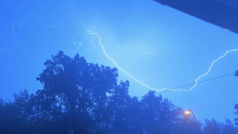 fork lightning giving a blue hue in the night sky