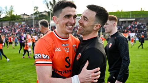 Rory Grugan is embraced by Armagh captain Aidan Forker after hitting the winning score at Clones