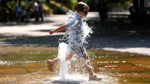 - A child plays in a fountain near the river Severn in Worcester.