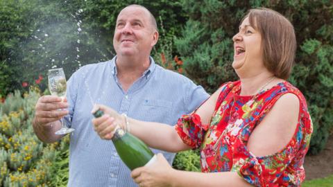 Alan and Claire Gray with champagne