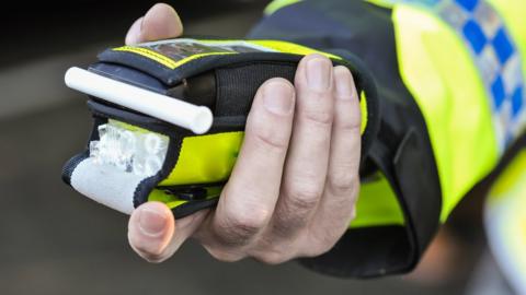 Police officer with breathalyser