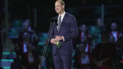 Prince William speaking on stage outside Windsor Castle speaking during the coronation concert