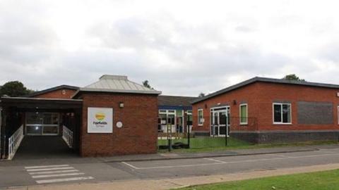 Single storey brick-built school buildings.