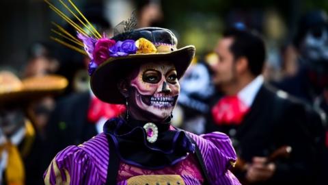 People fancy dressed as "Catrina" take part in the "Catrinas Parade" along Reforma Avenue, in Mexico City on October 22, 2017