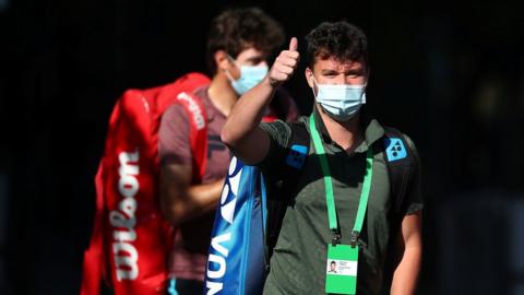 Tennis player Jonny O'Mara heading to training from his hotel quarantine room on 21 January