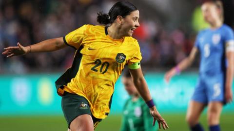 Sam Kerr celebrates scoring against England