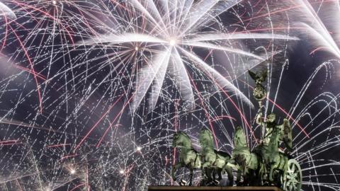 Fireworks illuminate the sky over the Quadriga statue of the Brandenburg Gate during New Year's Eve celebrations in Berlin