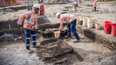 Four workers at the site of the discovery, a light rail network that is under construction