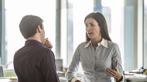 Man and woman talking in an office